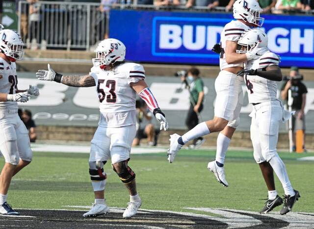 The Duquesne Dukes celebrate a win over Ohio in 2021. It was the Dukes’ first win over a Football Bowl Subdivision (FBS) opponent in program history.