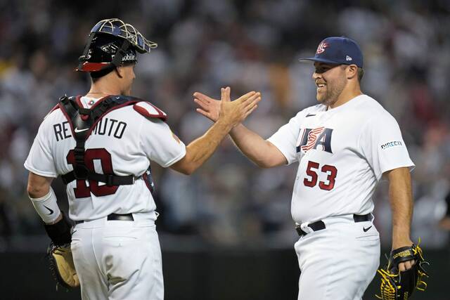 U.S. pitcher David Bednar, right, celebrates with catcher J.T. Realmuto after the team’s 6-2 victory over Great Britain in a World Baseball Classic game in Phoenix, Saturday, March 11, 2023. (AP Photo/Godofredo A. Vásquez)