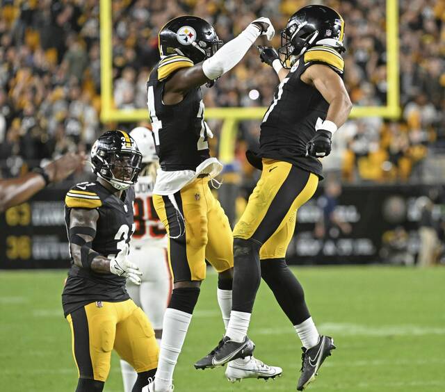 Joey Porter Jr., in the air to the left, celebrates with teammate Elijah Riley after Porter was on the defense during the fourth-down play that sealed last week’s win against the Cleveland Browns at Acrisure Stadium.
