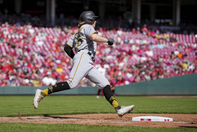 The Pirates’ Jack Suwinski runs the bases after hitting a solo home run during the fifth inning Sunday against the Reds.