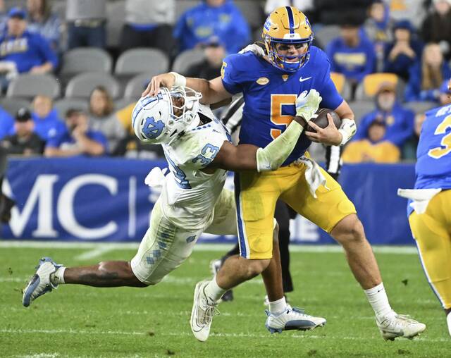 North Carolina’s Cedric Gray takes down Pitt’s Phil Jurkovec in the second quarter Saturday. Jurkovec was hurt on the play.