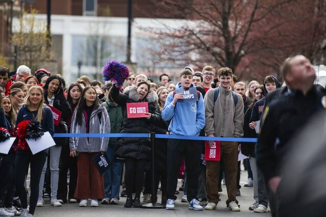 Fans and family members see off the Duquesne Dukes as they board buses for Nebraska on Tuesday, March 19, 2024, along Magee Street on the Duquesne University campus in Pittsburgh.