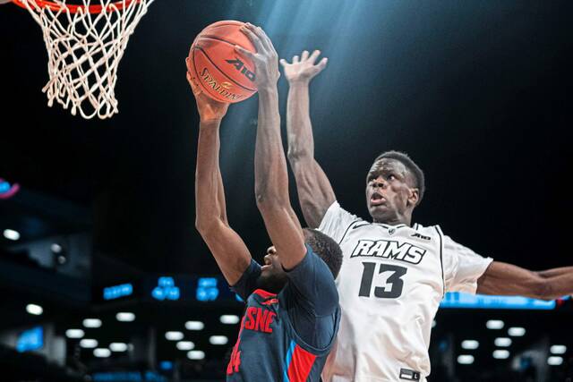 VCU’s Kuany Kuany attempts to block a shot attempt from Duquesne’s Fousseyni Drame during the championship game of the Atlantic 10 Conference tournament on Sunday, March 17, 2024, in New York.