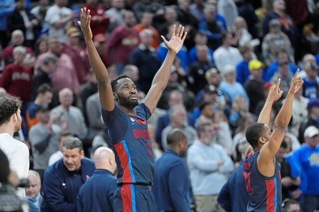 Duquesne forward David Dixon celebrates after a 71-67 win over BYU in the first round of the NCAA Tournament.