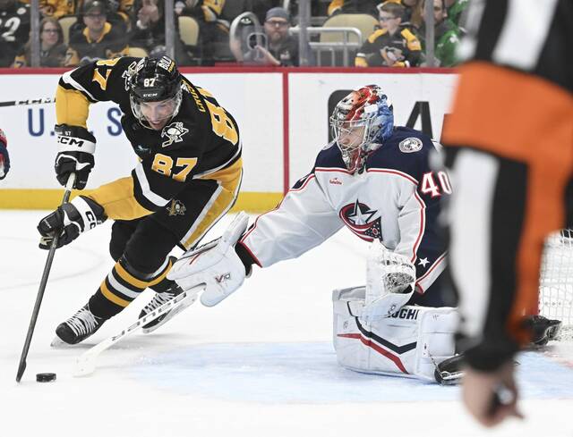 Blue Jackets goaltender Daniil Tarasov makes a save on the Penguins’ Sidney Crosby in the first period Thursday.