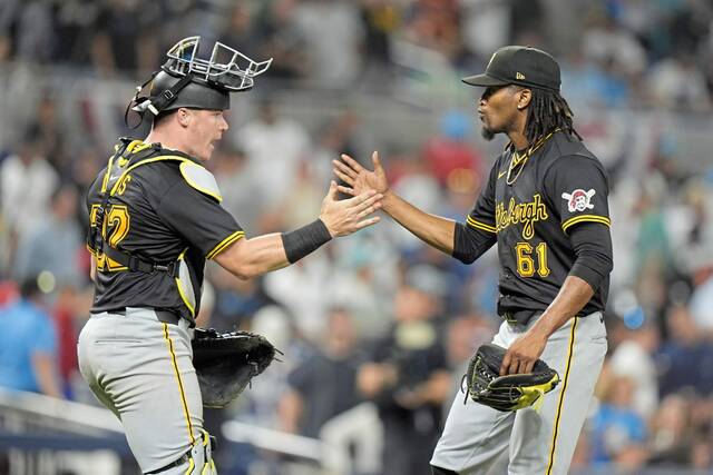 Pirates catcher Henry Davis (32) and relief pitcher Jose Hernandez (61) congratulate each other after the Pirates beat the Miami Marlins, 6-5, in 12 innings Thursday.