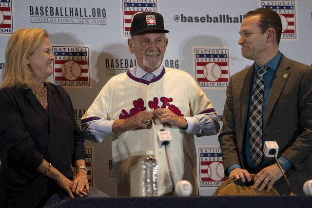Jim Leyland puts on a Hall of Fame jersey with Jane Forbes Clark (left) and Josh Rawitch of the National Baseball Hall of Fame and Museum during a news conference to announce Leyland’s election into the Hall on Dec. 4, 2023, in Nashville, Tenn.