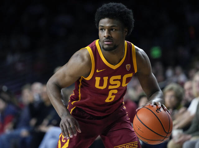 Southern California guard Bronny James dribbles the ball during the first half of an NCAA college basketball game against UCLA, Saturday, Jan. 27, 2024, in Los Angeles.