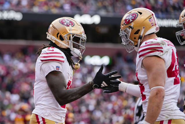 San Francisco 49ers wide receiver Brandon Aiyuk celebrates a touchdown with teammate fullback Kyle Juszczyk in a Dec. 31 game against the Washington Commanders in Landover, Md.