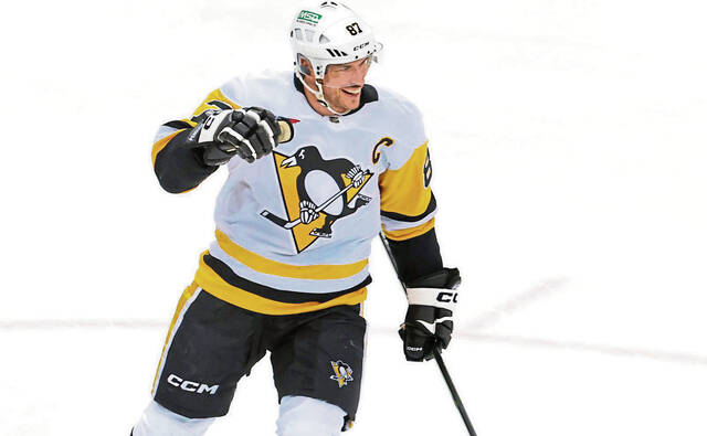 Pittsburgh Penguins center Sidney Crosby smiles after scoring a goal against the New Jersey Devils during the third period of an NHL hockey game April 2, 2024, in Newark, N.J.