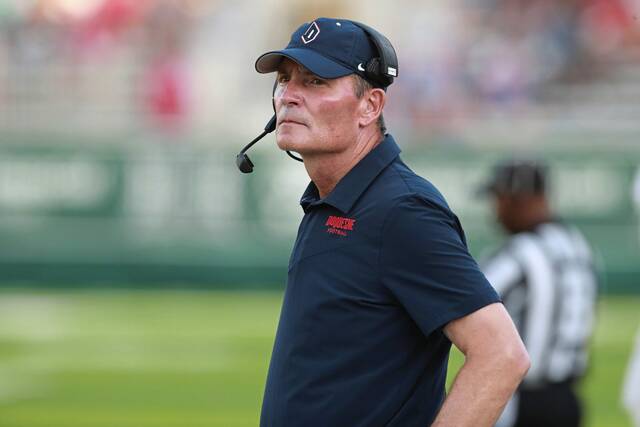 Duquesne coach Jerry Schmitt stands on the sideline before the team’s NCAA college football game against Hawaii on Saturday, Sept. 17, 2022, in Honolulu.