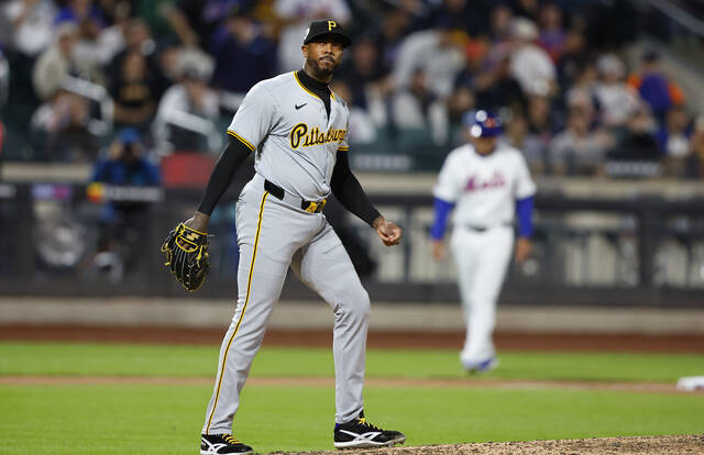 Pittsburgh Pirates pitcher Aroldis Chapman reacts after giving up hits against the New York Mets during the eighth inning of a baseball game, Monday, April 15, 2024, in New York.