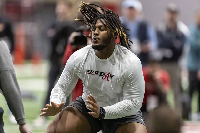 Former Alabama offensive lineman J.C. Latham works in position drills at Alabama’s NFL pro day on March 20 in Tuscaloosa, Ala.