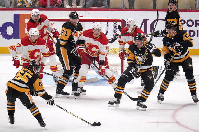 Penguins defenseman Erik Karlsson (65) controls the puck during a power play against the Calgary Flames last season.
