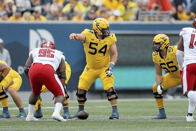 West Virginia’s Zach Frazier (54) calls signals at the line against Texas Tech during an NCAA football game on Saturday, Sept. 23, 2023, in Morgantown, W. Va.