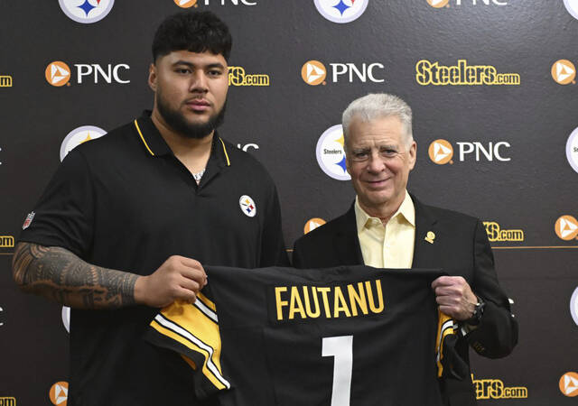 Steelers’ first-round pick Troy Fautanu poses with Art Rooney II on at the UPMC Rooney Sports Performance Complex.