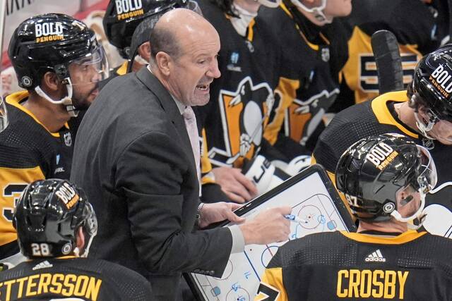 Pittsburgh Penguins assistant coach Todd Reirden, center, gives instructions during the third period of an NHL hockey game against the Buffalo Sabres, Saturday, Jan. 6, 2024 in Pittsburgh.