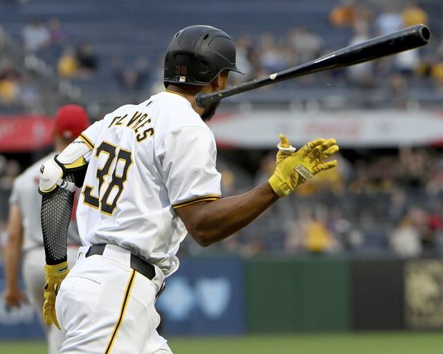 The Pirates’ Edward Olivares tosses his bat after hitting a grand slam against the Angels on Monday at PNC Park.