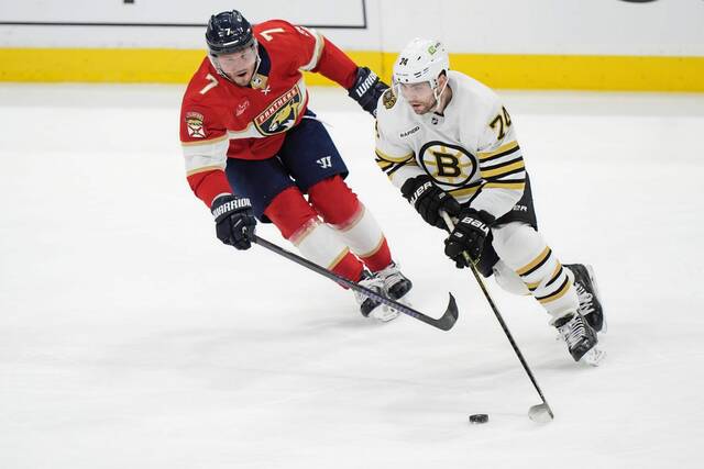 Boston Bruins left wing Jake DeBrusk (74) takes the puck down the ice against Florida Panthers defenseman Dmitry Kulikov (7) during the second period of Game 1 of the second-round series of the Stanley Cup Playoffs, Monday, May 6, 2024, in Sunrise, Fla. 
                                AP