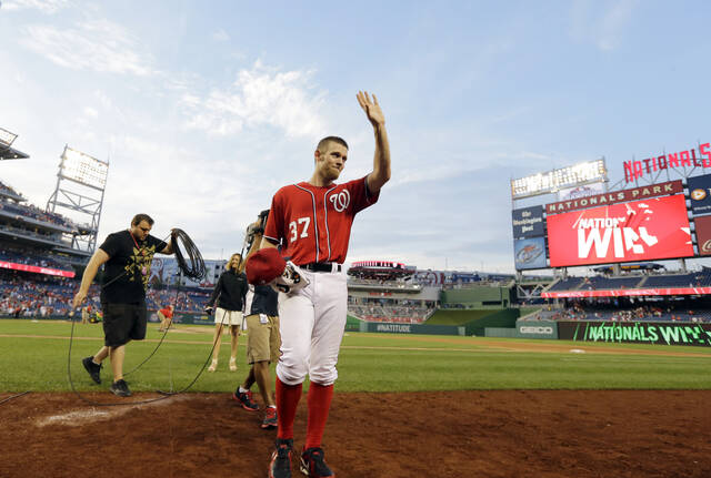 Washington Nationals pitcher Stephen Strasburg acknowledges fans as he comes off the field after a game against the Philadelphia Phillies at Nationals Park, Aug. 11, 2013, in Washington. Strasburg, the 2019 World Series MVP whose career was derailed by injuries, officially was listed by Major League Baseball on Saturday, April 6, 2024, as being retired.