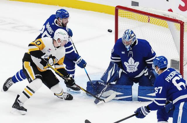 Maple Leafs goaltender Anthony Stolarz (41) makes a save as the Penguins’ Drew O’Connor (10) and Maple Leafs’ Conor Timmins (25) battle for a rebound during the first period Saturday.