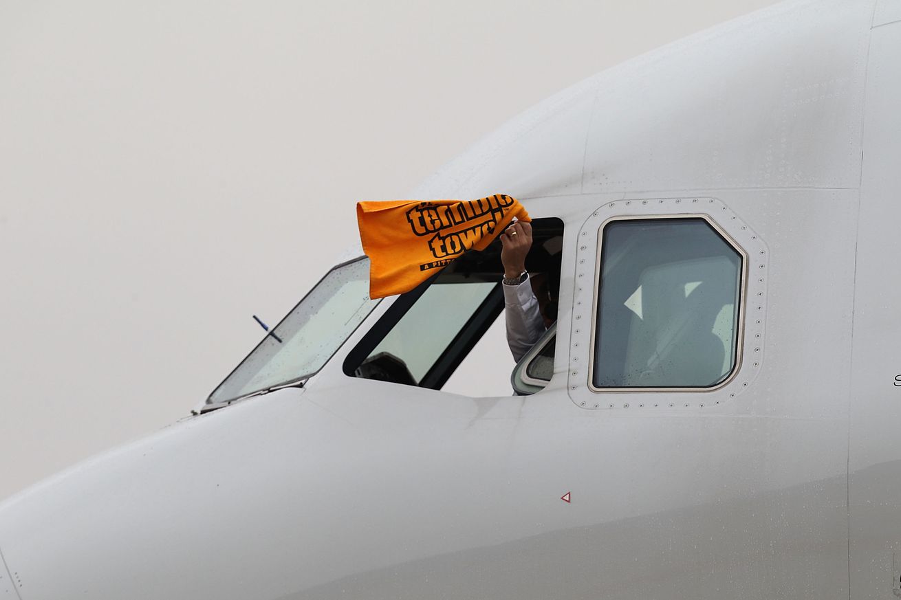 A US Airway pilot waves “the terrible towel” as he taxis the plane with the AFC Championship Pittsburgh Steelers at Dallas Fort Worth International Airport on January 31, 2011 in Dallas, Texas. The Pittsburgh Steelers will play the Green Bay Packers in Super Bowl XLV on February 6, 2011 at Cowboys Stadium.
