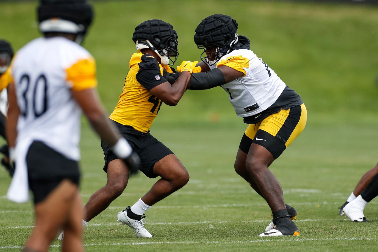 Pittsburgh Steelers offensive tackle Broderick Jones (77) participates in a drill with linebacker Quincy Roche (48) during the team’s training camp at Saint Vincent College on July 29, 2023, in Latrobe, PA.
