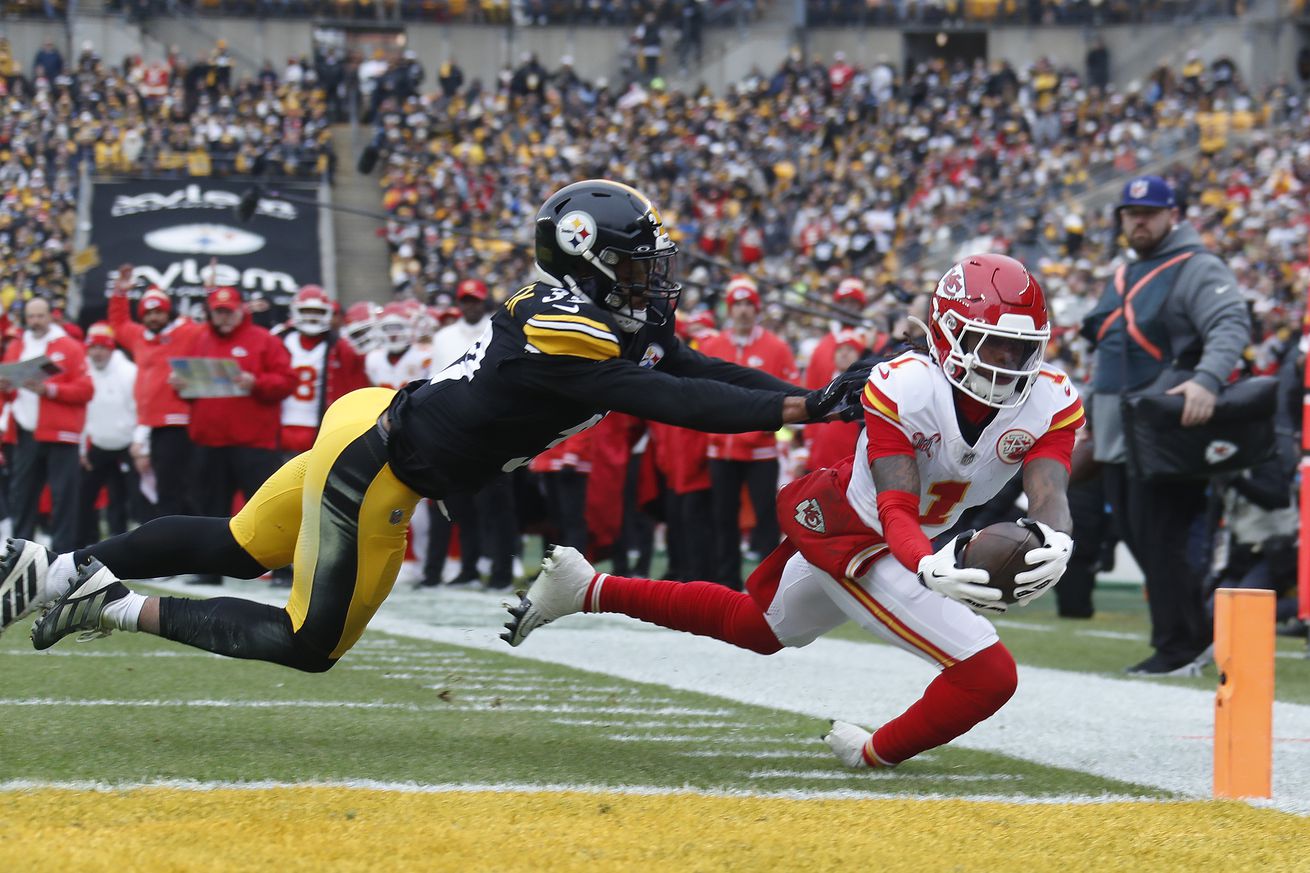 Kansas City Chiefs wide receiver Xavier Worthy (1) dives past Pittsburgh Steelers safety Minkah Fitzpatrick (39) into the end-zone for a touchdown during the first quarter at Acrisure Stadium.