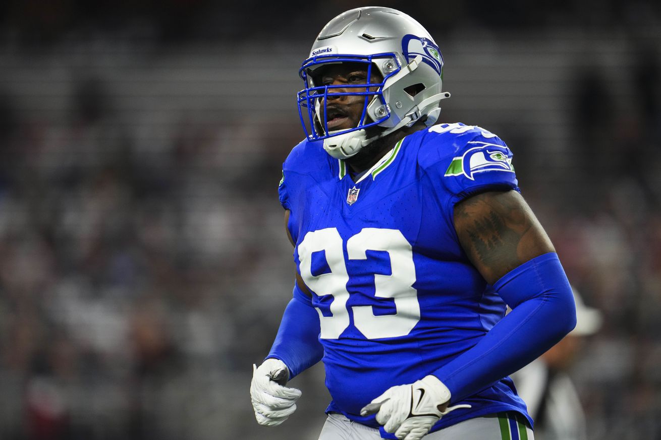 Cameron Young #93 of the Seattle Seahawks runs across the field during an NFL football game against the Dallas Cowboys at AT&T Stadium on November 30, 2023 in Arlington, Texas.