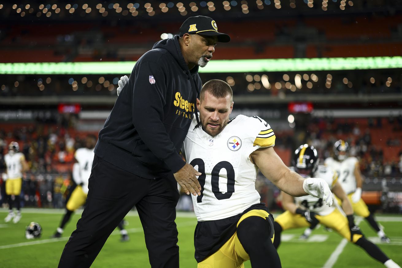 Defensive coordinator Teryl Austin of the Pittsburgh Steelers hugs T.J. Watt #90 prior to an NFL football game against the Cleveland Browns at Huntington Bank Field on November 21, 2024 in Cleveland, Ohio.