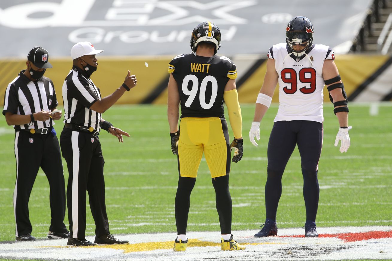 NFL referee Shawn Smith (14) flips the coin as brothers Pittsburgh Steelers outside linebacker T.J. Watt (90) and Houston Texans defensive end J.J. Watt (99) take part before their game against at Heinz Field. The Steelers won 28-21. Mandatory Credit: Charles LeClaire