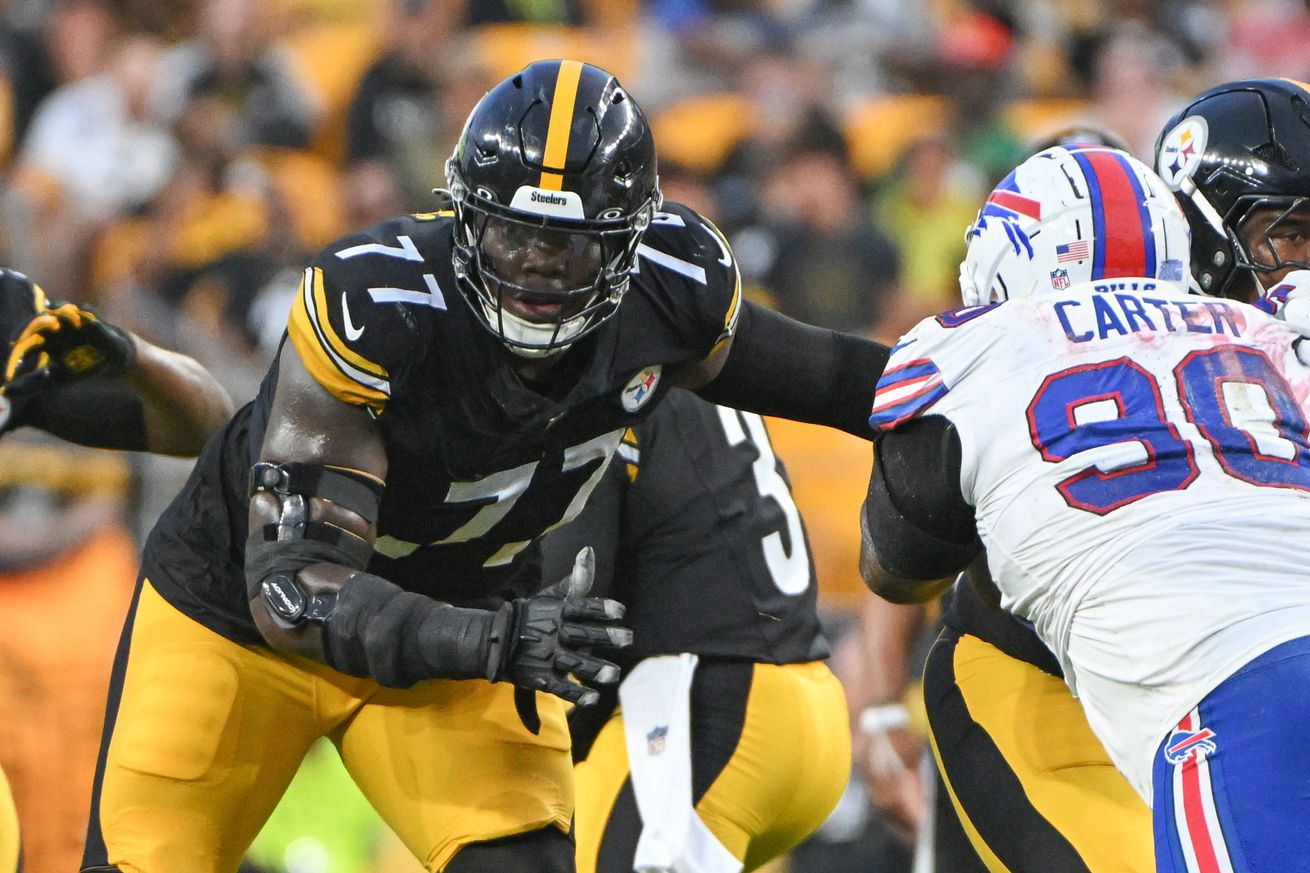 Pittsburgh Steelers offensive tackle Broderick Jones sets to fend off a Buffalo Bills defender during a 2024 preseason contest from Acrisure Stadium.
