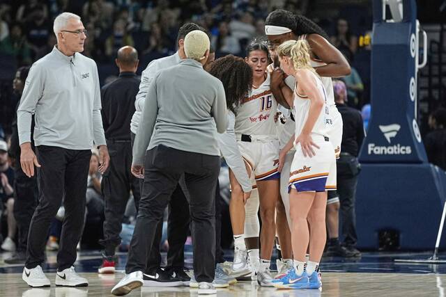 Phoenix Mercury guard Megan McConnell (16) is helped off the court after sustaining an injury during the second half of a game against the Minnesota Lynx on Tuesday.