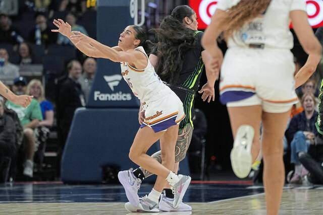 Mercury guard Megan McConnell (16) collides with Lynx forward Alissa Pili on June 3. McConnell left the game because of an injury from the play.