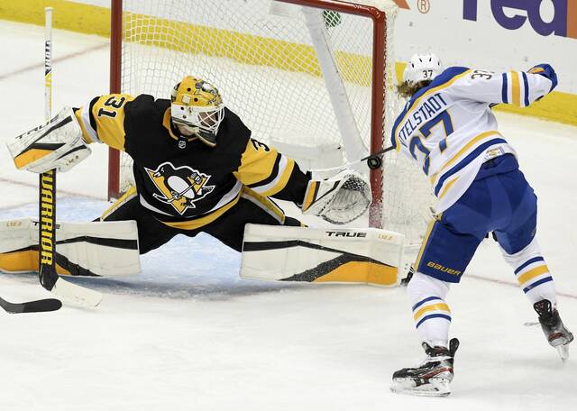 Penguins goaltender Maxime Lagace makes a glove save against Sabres forward Casey Mittelstadt in the second period of a game at PPG Paints Arena, May 08, 2021.