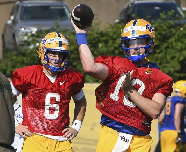 Quarterback Eli Holstein (10) looks to make a pass as teammate Mason Heintschel looks on during the first day of Pitt football practice Wednesday, July 30, 2025, at UPMC Rooney Sports Complex on the South Side.