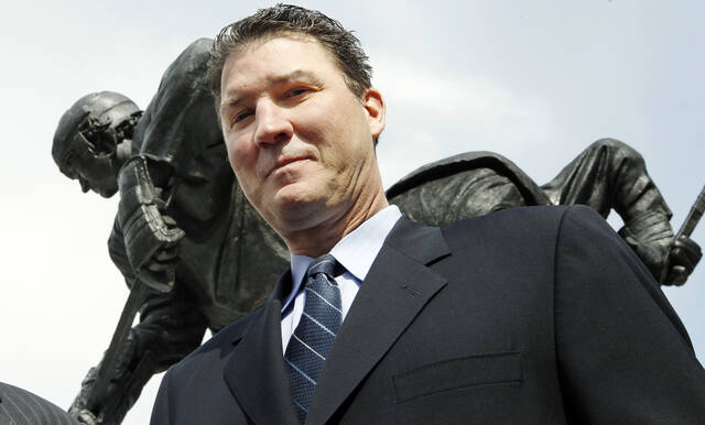 From March 7, 2012: Penguins Hall of Fame center Mario Lemieux stands near the statue of him outside of PPG Paints Arena in Pittsburgh.