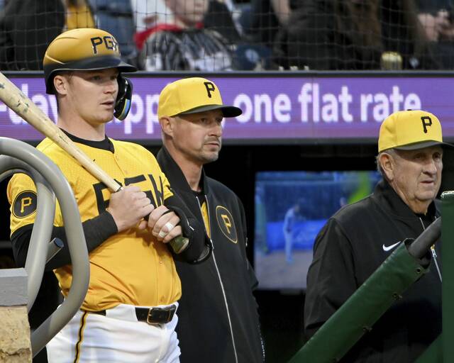 Pirates catcher Henry Davis waits to bat next to manager Don Kelly and Gene Lamont during a game against the Brewers on May 23, 2025, at PNC Park.