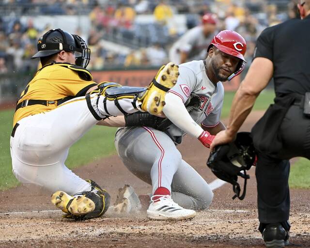 Pirates catcher Henry Davis tags out the Reds’ Miguel Andujar at home plate during the fourth inning Friday at PNC Park.