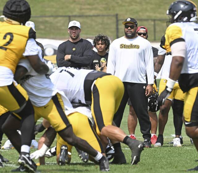 The Steelers’ T.J. Watt (left) and Cam Heyward look on during practice Aug. 7, 2025 at Saint Vincent College.