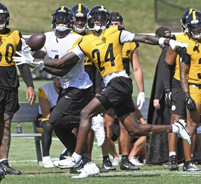 Pittsburgh Steelers cornerback Joey Porter Jr. (No. 24) breaks up a pass intended for wide receiver DK Metcalf during Monday’s training-camp practice at Saint Vincent College.