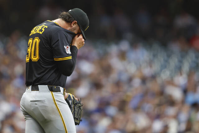 Pirates starting pitcher Paul Skenes wipes his face during the fourth inning against the Brewers on Tuesday in Milwaukee. Skenes gave up two earned runs in the inning and four overall in four innings.