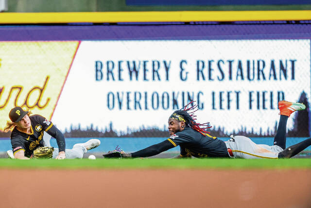 Pittsburgh Pirates’ Jack Suwinski, left, and Oneil Cruz can’t catch a double by the Milwaukee Brewers’ Joey Ortiz during the fourth inning of a baseball game, Tuesday, Aug. 12, 2025, in Milwaukee.