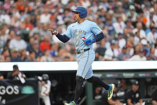 Toronto Blue Jays’ George Springer scores against the Detroit Tigers during the sixth inning of a baseball game Thursday, July 24, 2025, in Detroit.