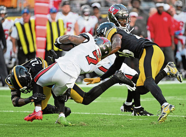 The Steelers’ Juan Thornhill drops the Bucs’ Bucky Irving for a loss in the first quarter Saturday.