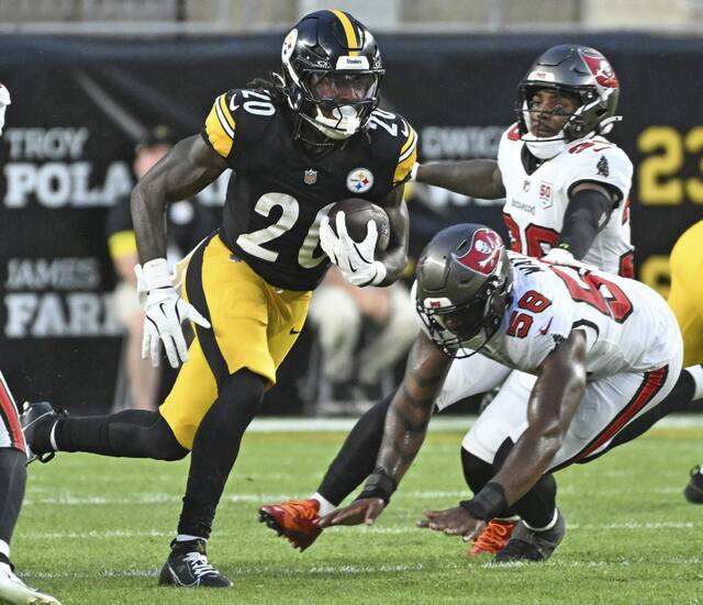 Steelers running back Kaleb Johnson cuts back on the Bucs’ Markees Watts in the second quarter Saturday at Acrisure Stadium.