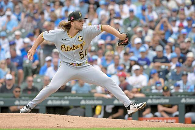 Pirates starting pitcher Carmen Mlodzinski delivers against the Cubs during the first inning Sunday.