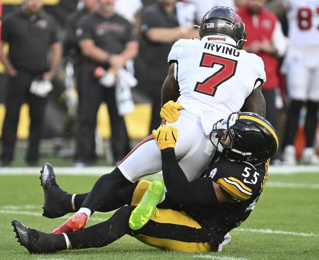 Steelers linebacker Cole Holcomb drop the Bucs’ Bucky Irving in the first quarter Saturday.