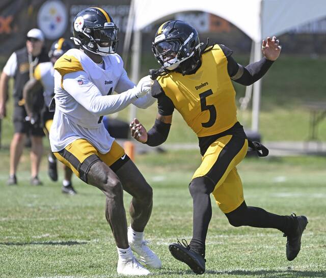 Pittsburgh Steelers defensive back Jalen Ramsey (No. 5 in gold) tussles with receiver DK Metcalf during a training-camp practice at Saint Vincent College earlier this month.