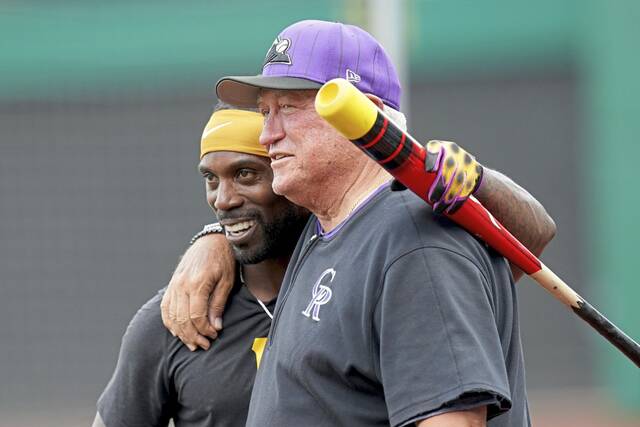 Rockies interim bench coach Clint Hurdle hugs the Pirates’ Andrew McCutchen before Friday’s game at PNC Park.